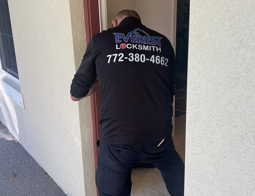 everest man dressed in black stands before a door