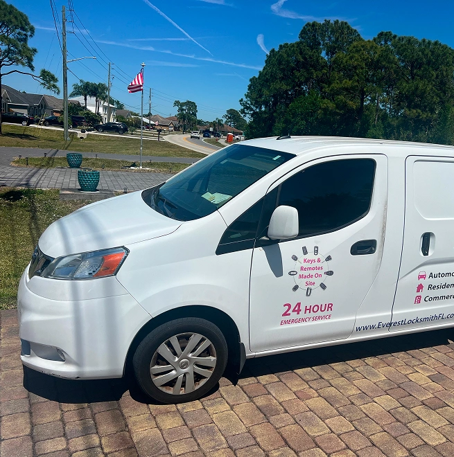 everest white van parked on a brick driveway